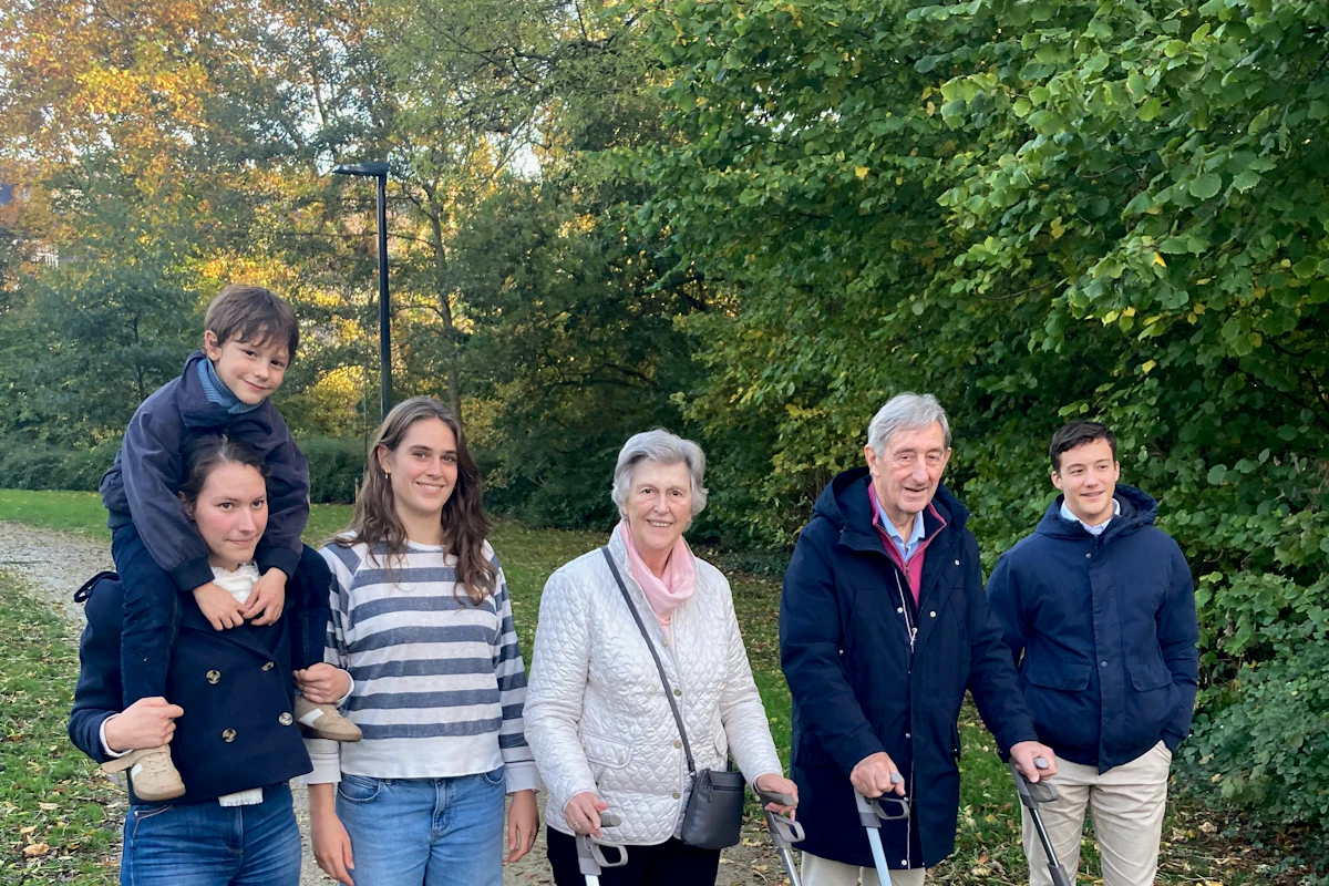 Three generations of a family out for a walk in a park