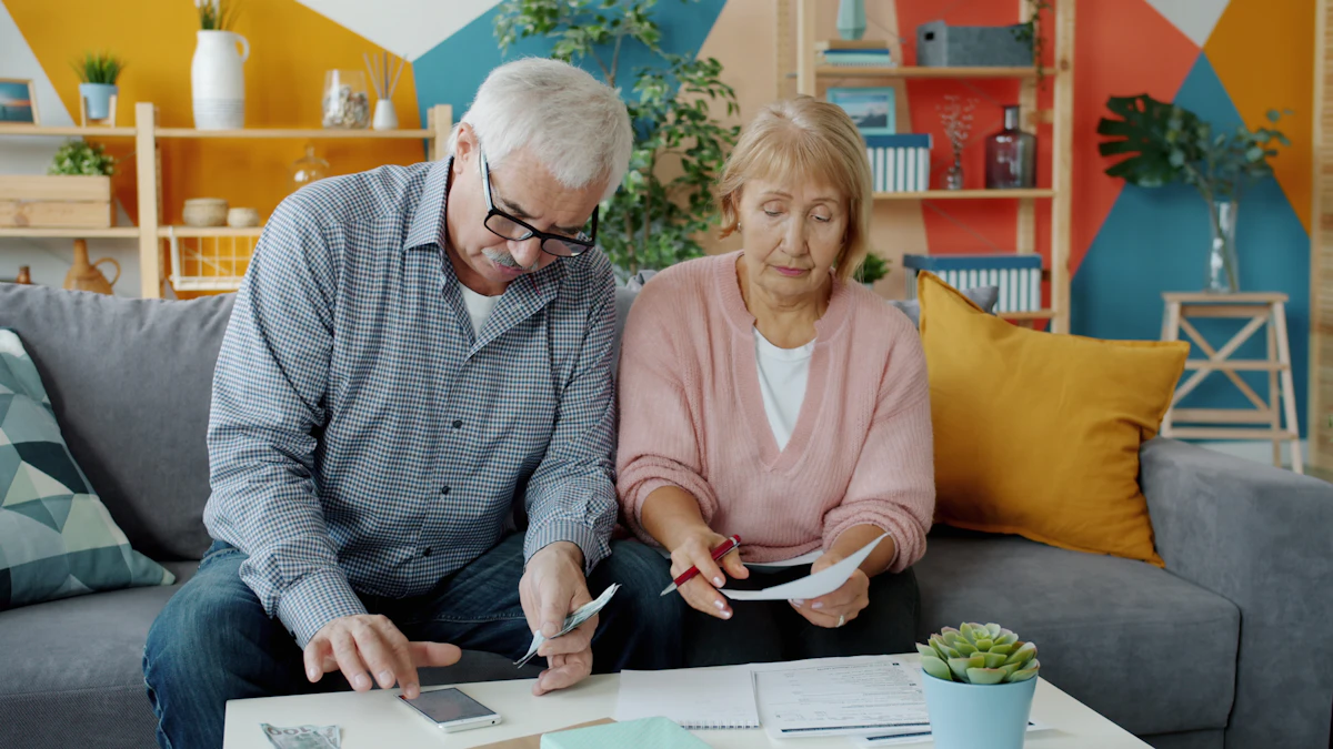 An older couple on their sofa, going over their paperwork together